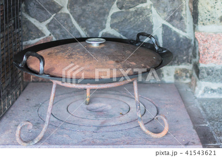 Cast iron wok on a wood stove 41543621