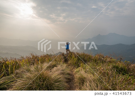 A man take a photo at the top of Phu Chi Fa. 41543673