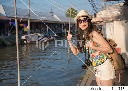 woman standing on the river bank woman standing on the river bank 41544553