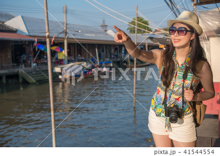 woman stand on river bank and point to the front woman stand on river bank and point to the front 41544554