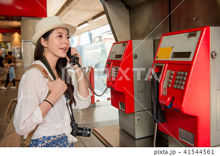 woman is talking on the public phone 41544561