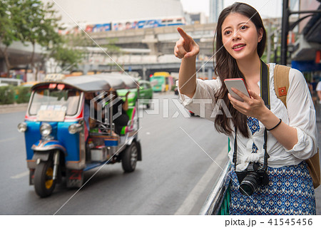 woman traveller standing beside the street woman traveller standing beside the street 41545456
