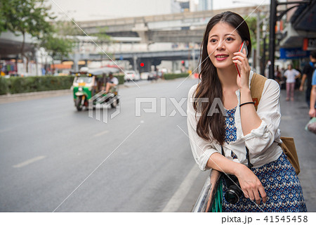 female backpacker talking on the phone female backpacker talking on the phone 41545458