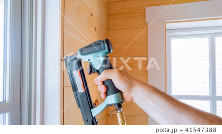 Carpenter brad using nail gun to molding Carpenter brad using nail gun to molding 41547388