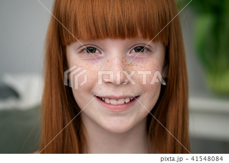 Happy Little Ginger Girl With Freckles Smilingの写真素材