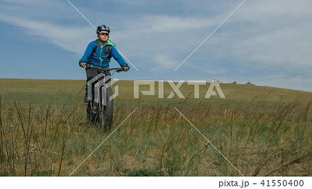 Fat bike also called fatbike or fat-tire bike in summer driving hills. 41550400