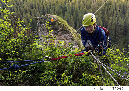 girl climber begin descent from the cliff 41550994
