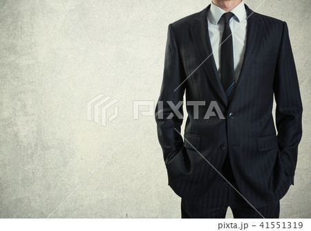 A man in suit on a concrete wall background A man in suit on a concrete wall background 41551319