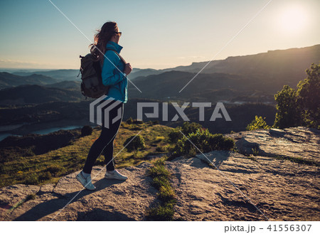 Woman hiker on a top of a mountain Woman hiker on a top of a mountain 41556307