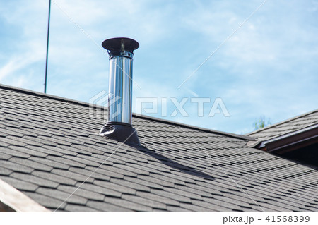 Chimney pipe from stainless steel on the roof of the house. 41568399