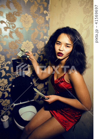 pretty young african american woman in luxury restroom with mone pretty young african american woman in luxury restroom with mone 41569697