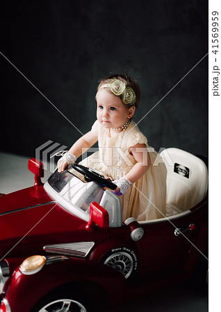 girl dressed as bride playing with toy car girl dressed as bride playing with toy car 41569959