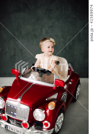 girl dressed as bride playing with toy car 41569974
