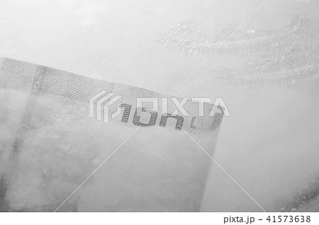 Thai banknote freezing in ice on plastic tray Thai banknote freezing in ice on plastic tray 41573638
