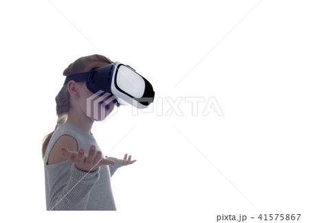 Girl using a virtual reality headset Girl using a virtual reality headset 41575867