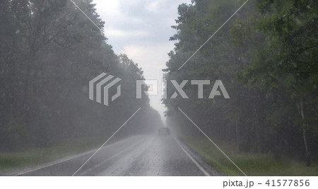 Road during heavy rain. Car on asphalt Road during heavy rain. Car on asphalt 41577856