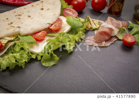 Piadina romagnola with cheese and ham 41577890