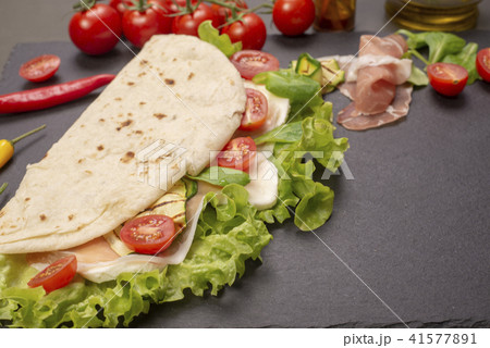 Piadina romagnola with cheese and ham Piadina romagnola with cheese and ham 41577891