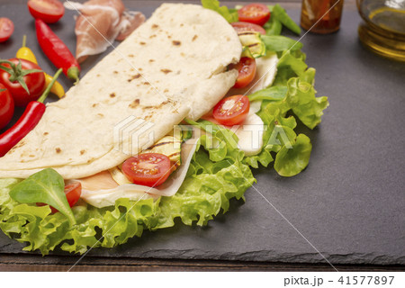 Piadina romagnola with cheese and ham Piadina romagnola with cheese and ham 41577897