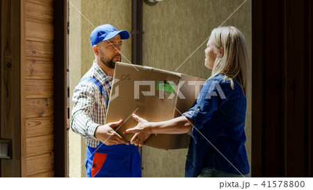 Woman receiving mail box with courier Woman receiving mail box with courier 41578800