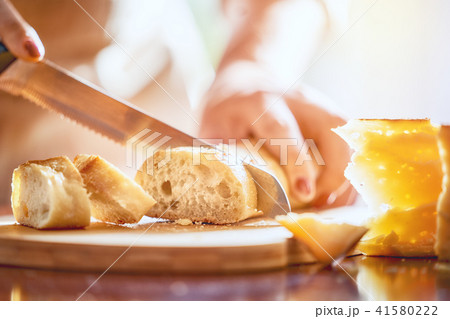 person cutting bread person cutting bread 41580222