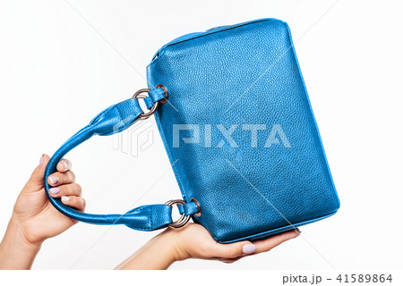 female hand holding blue bag isolated 41589864