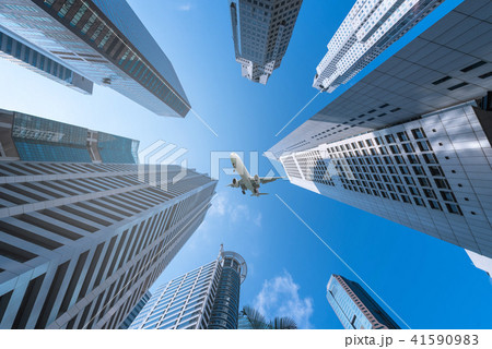 Plane flying over city on blue sky background. Plane flying over city on blue sky background. 41590983
