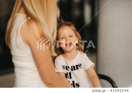 Mother and daughter outdoors in city. playing and having fun. Fashion happy mother and child 41591544