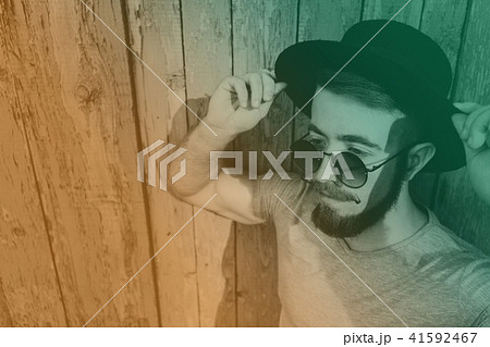 Bearded hipster man in hat and sunglasses Bearded hipster man in hat and sunglasses 41592467
