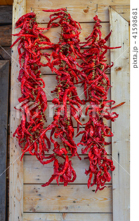 Hanging red chilli on wooden wall 41598681