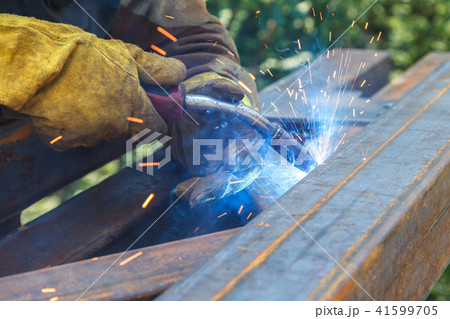 Worker welding in a factory.  41599705