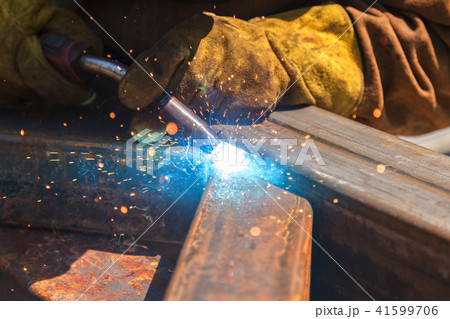 Worker welding in a factory.  41599706