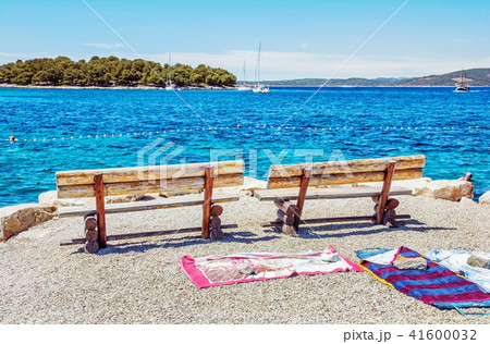 Wooden benches and towels on the beach, Solta 41600032
