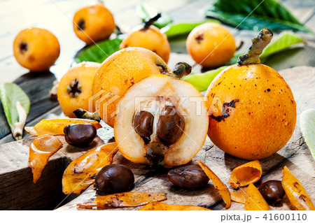 Fresh loquats on wooden background 41600110