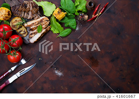 Fresh three types of grilled steak (chicken, pork, beef) on slate plate with herbs, tomato and 41601667