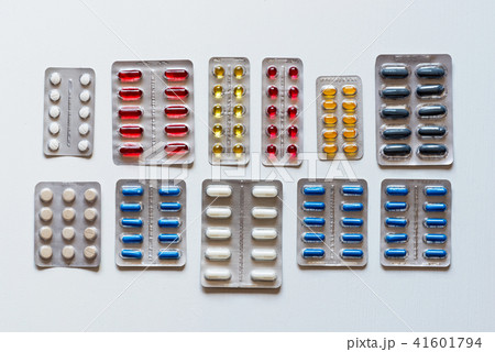 Set of blisters of colorful pills on a white background. Flat lay. Set of blisters of colorful pills on a white background. Flat lay. 41601794