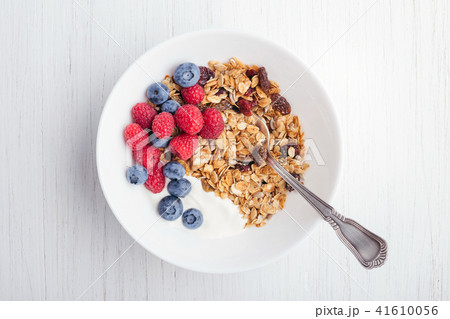 Granola with yogurt in bowl. 41610056