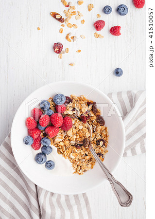 Granola with yogurt in bowl. 41610057