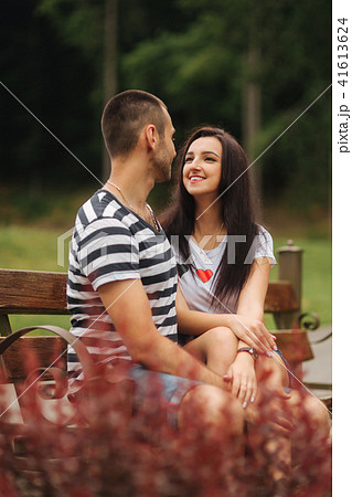 Young couple in love spending time together and sit on the bench 41613624