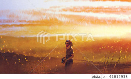 traveler with a camera standing against sunset 41615953