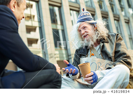 Poor refugee telling his personal story to office worker 41619834