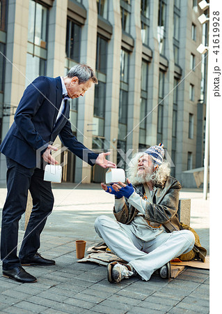 Elderly hippy man feeling thankful while getting some food 41619928