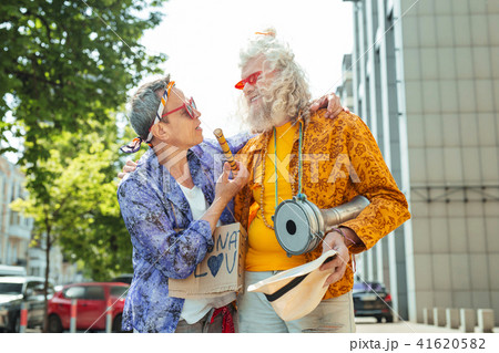 Long-haired hippy man smiling to his happy friend 41620582