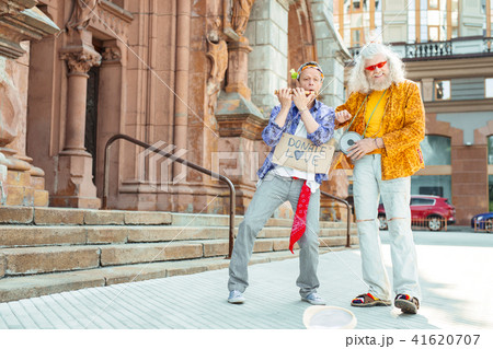 Two bright positive men dancing and singing together 41620707