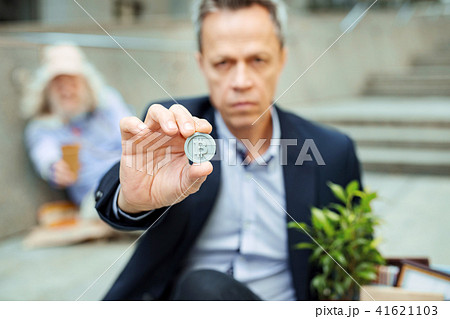 Skillful smart office manager putting token out of pocket 41621103