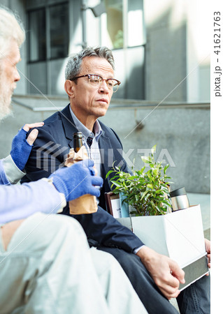 Long-haired hippy wearing light clothes drinking beer 41621763