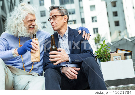 Just fired depressed man in glasses drinking beer 41621784