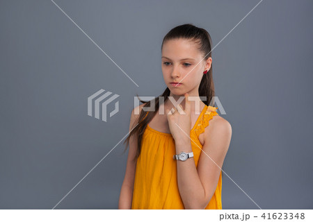 Pretty teenage girl thinking about something intently 41623348