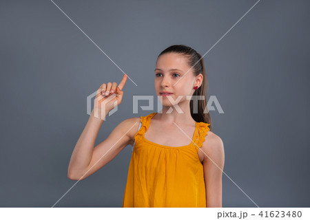 Pleasant teenage girl attracting someones attention Pleasant teenage girl attracting someones attention 41623480
