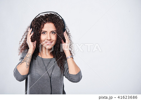 Woman listening to music in headphones Woman listening to music in headphones 41623686
